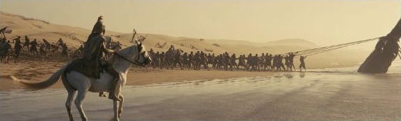 Riders on a beach at dawn