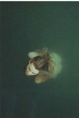 Face submerged in dark water