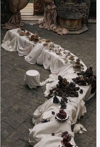 Draped banquet table with dark fruit