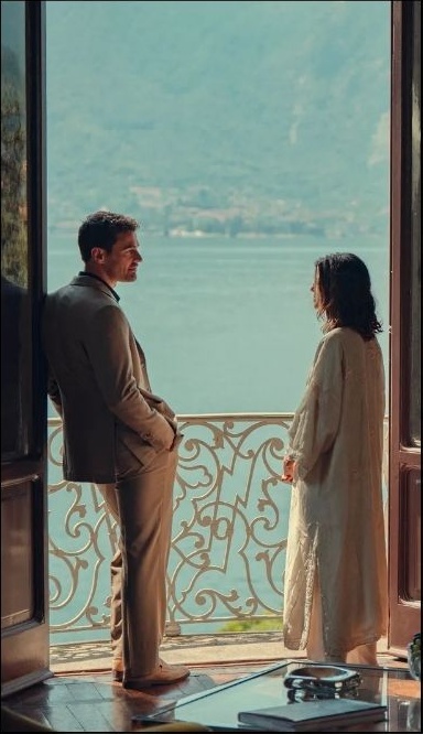 Two characters on a lakeside balcony
